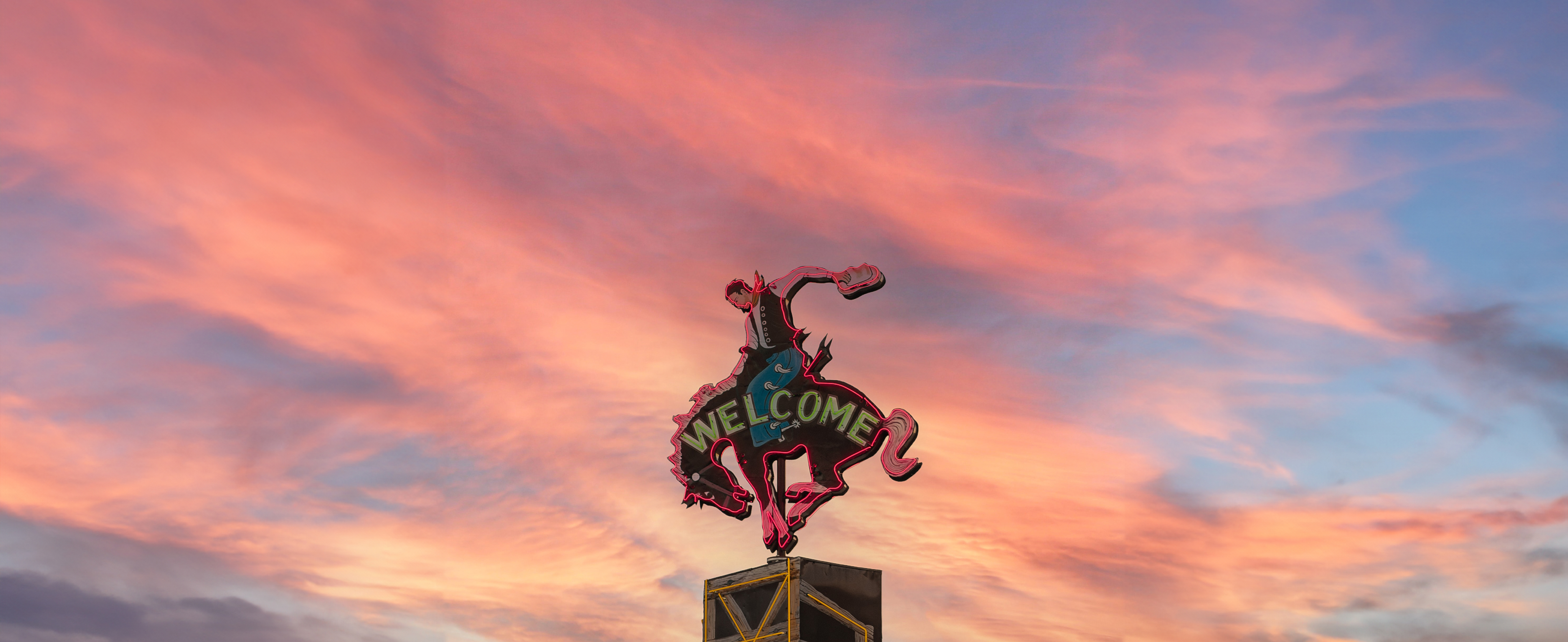 neon cowboy welcome sign