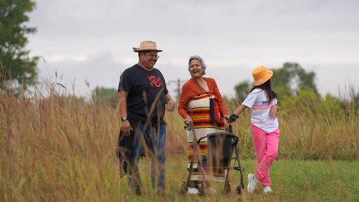 Otoe-Missouria tribe members walk in a prairie