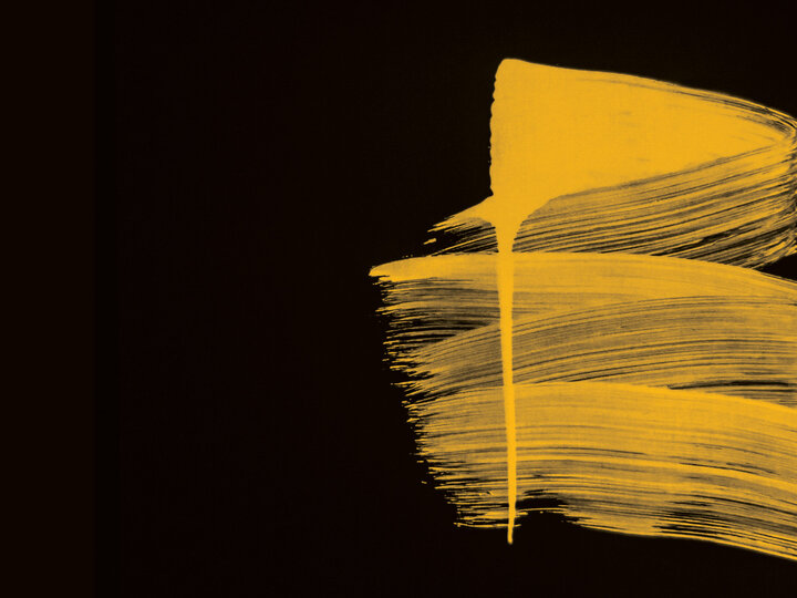 yellow paint on black background